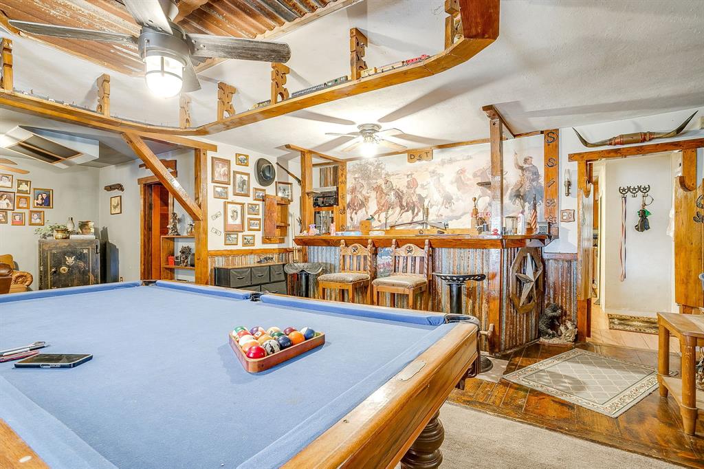 1035 Summit Drive Springtown, TX 76082 - Photo 14 of 38 Playroom with a dry bar, billiards, a ceiling fan, a wainscoted wall, and wood finished floors