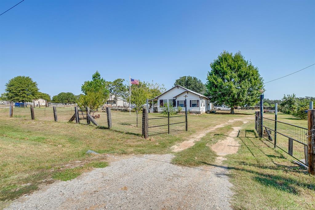 1035 Summit Drive Springtown, TX 76082 - Photo 5 of 38 View of dirt / gravel road with a gated entry, a gate, and a view of countryside