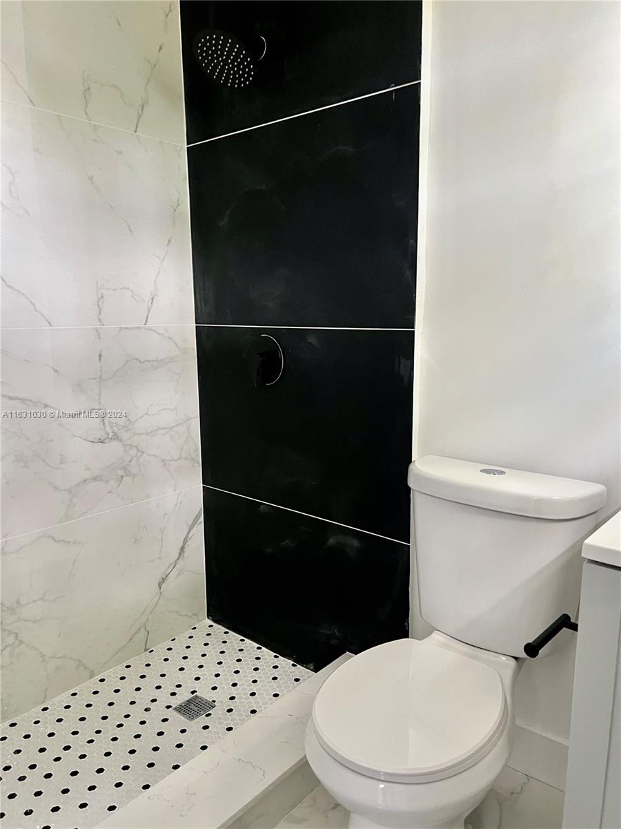 945 Curtiss Drive Opa-Locka, FL 33054 - Photo 15 of 18 a bathroom with a toilet and a shower