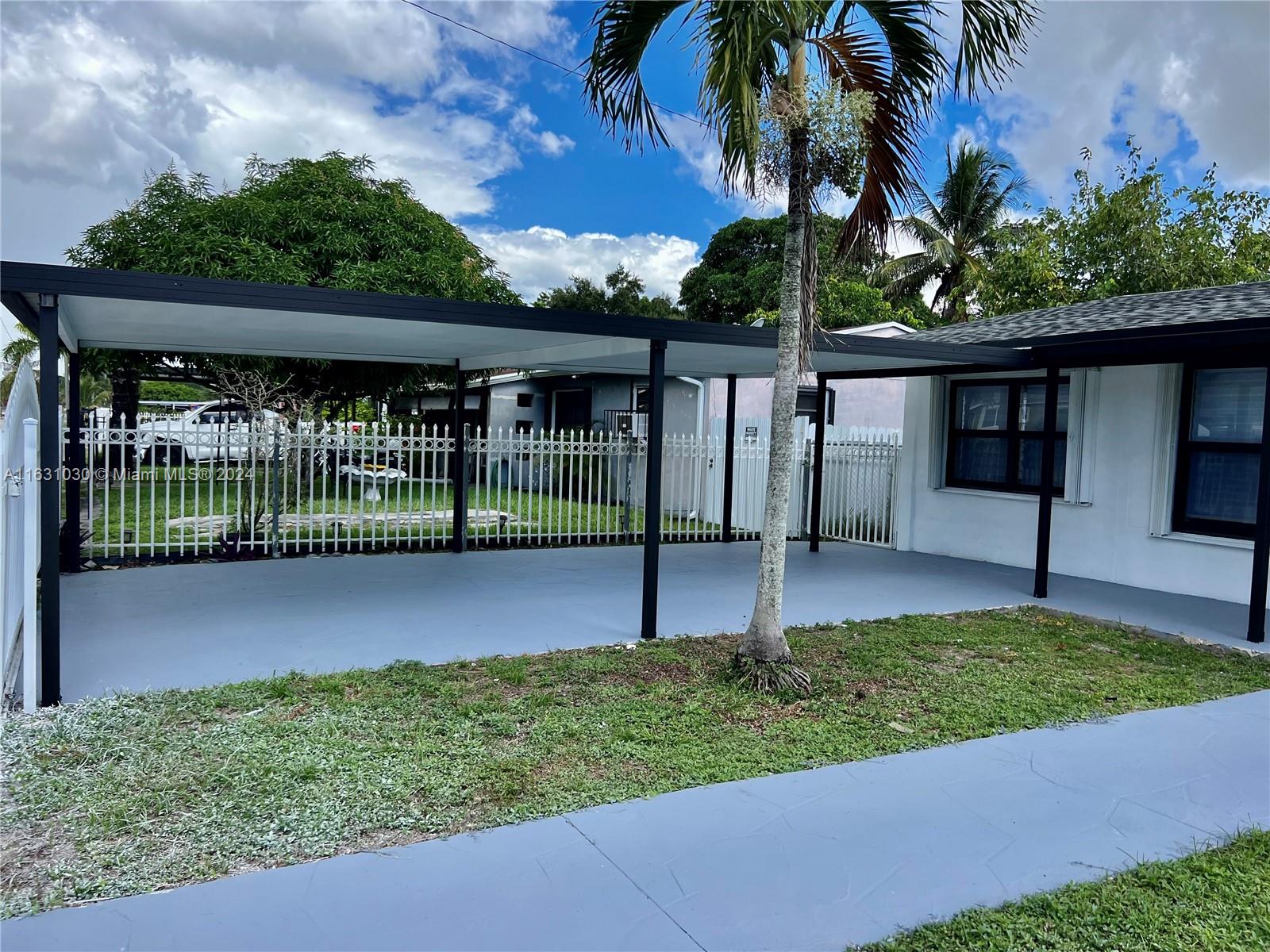 945 Curtiss Drive Opa-Locka, FL 33054 - Photo 3 of 18 a view of a backyard with a garden