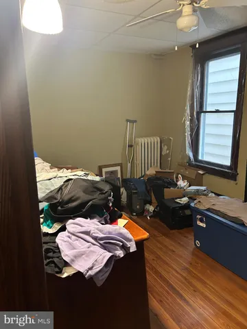 a blue bed sitting in a kitchen next to a window