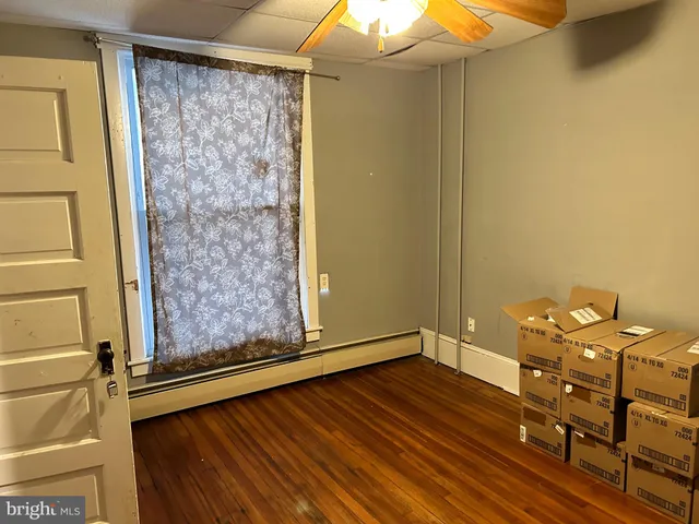 a view of a room with wooden floor and chair