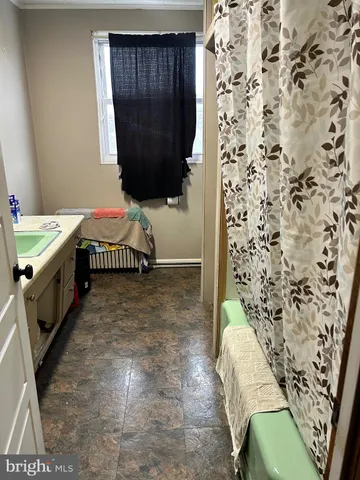 a view of a room with gym equipment and a window