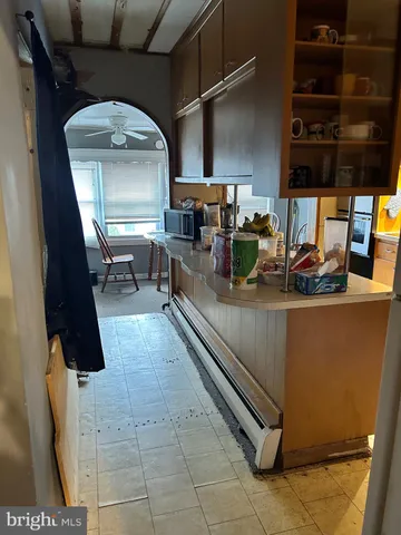 a kitchen with sink a faucet and chairs