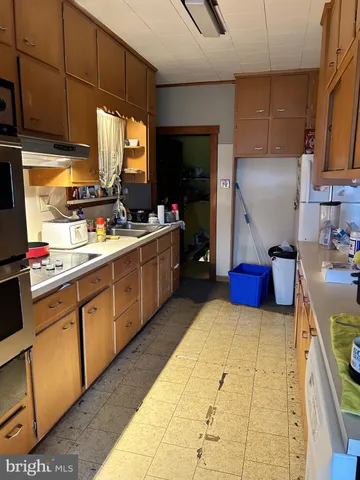 a white refrigerator freezer sitting inside of a kitchen