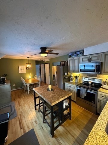 212 Arnold Road Sturbridge, MA 01518 - Photo 3 of 21 a kitchen with stainless steel appliances granite countertop a stove and a refrigerator