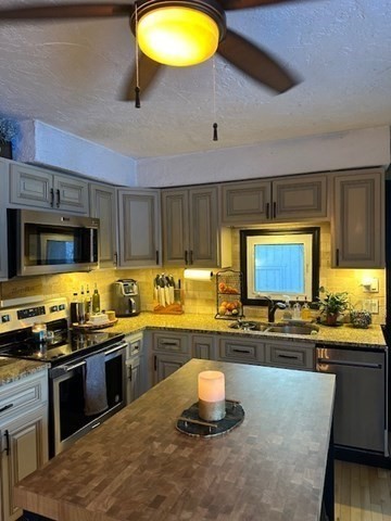212 Arnold Road Sturbridge, MA 01518 - Photo 4 of 21 a kitchen with stainless steel appliances a stove a sink and a microwave