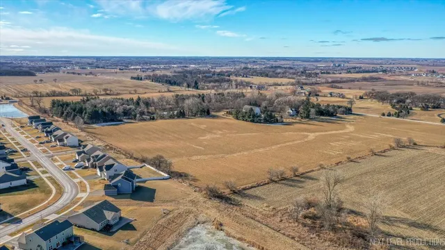 a view of a house with a big yard and large trees