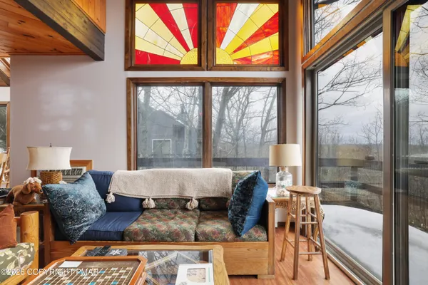 a living room with furniture a rug and a chandelier
