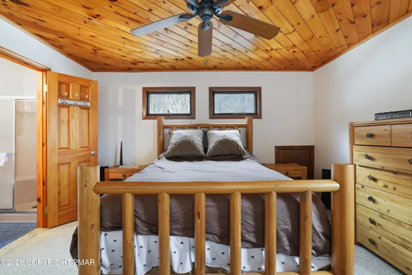 a bedroom with bed and window