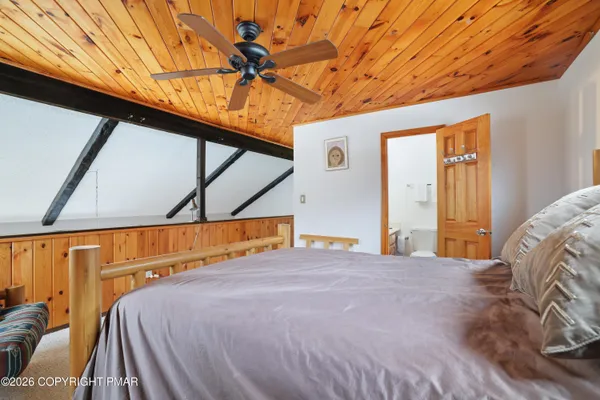 a bed room with a bed and a television