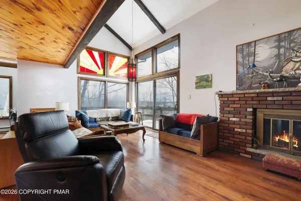a spacious bedroom with two beds and a chandelier