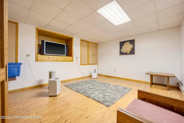 a view of a house with a yard covered in snow