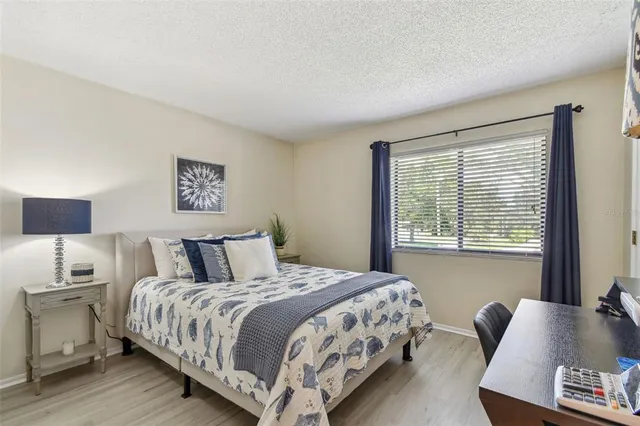 a bedroom with a bed and a couch