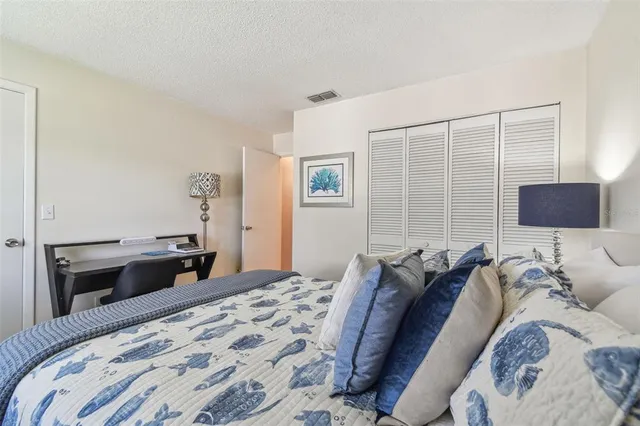 a bedroom with a bed and a lamp