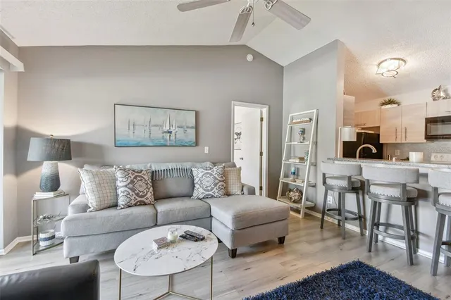 a living room with furniture and a dining table