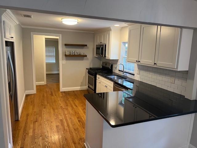 a kitchen with kitchen island granite countertop a sink a stove and refrigerator