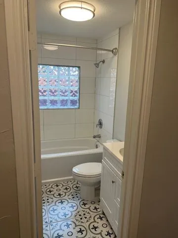 a bathroom with a bathtub and toilet