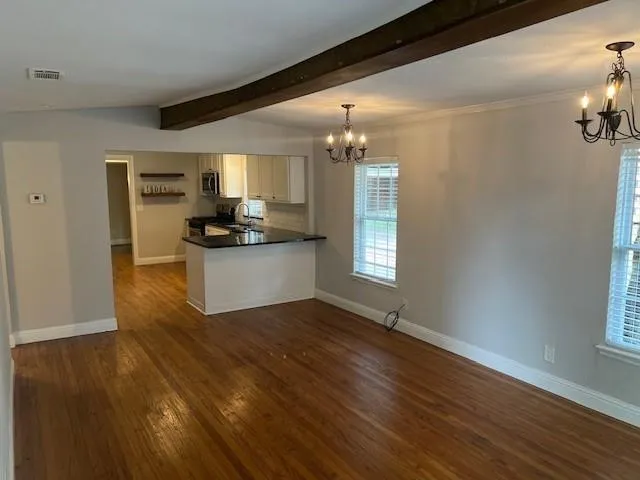 a kitchen with granite countertop a sink and cabinets