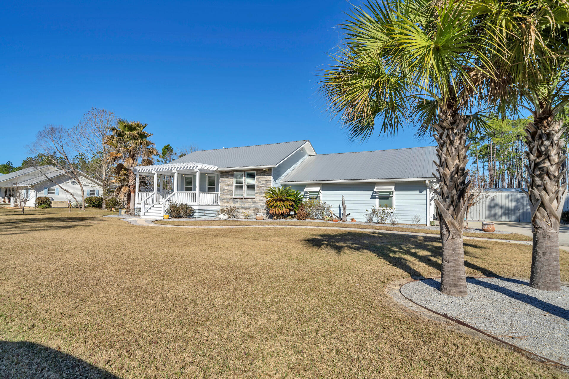 90 Delbert Lane Santa Rosa Beach, FL 32459 - Photo 2 of 47 a front view of a house with a garden and tree