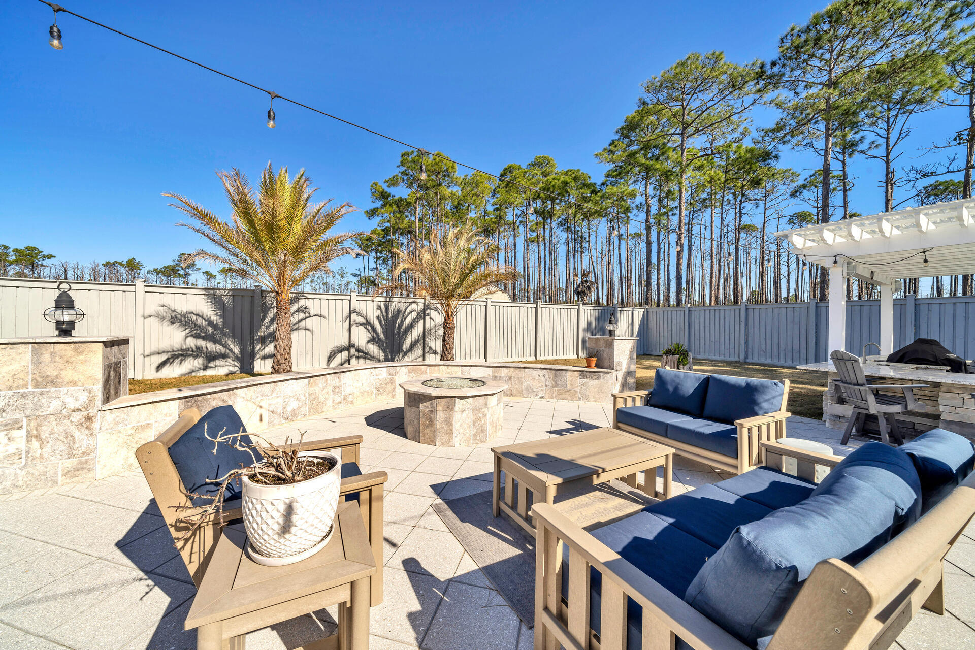 90 Delbert Lane Santa Rosa Beach, FL 32459 - Photo 41 of 47 a view of a patio with couches table and chairs and potted plants