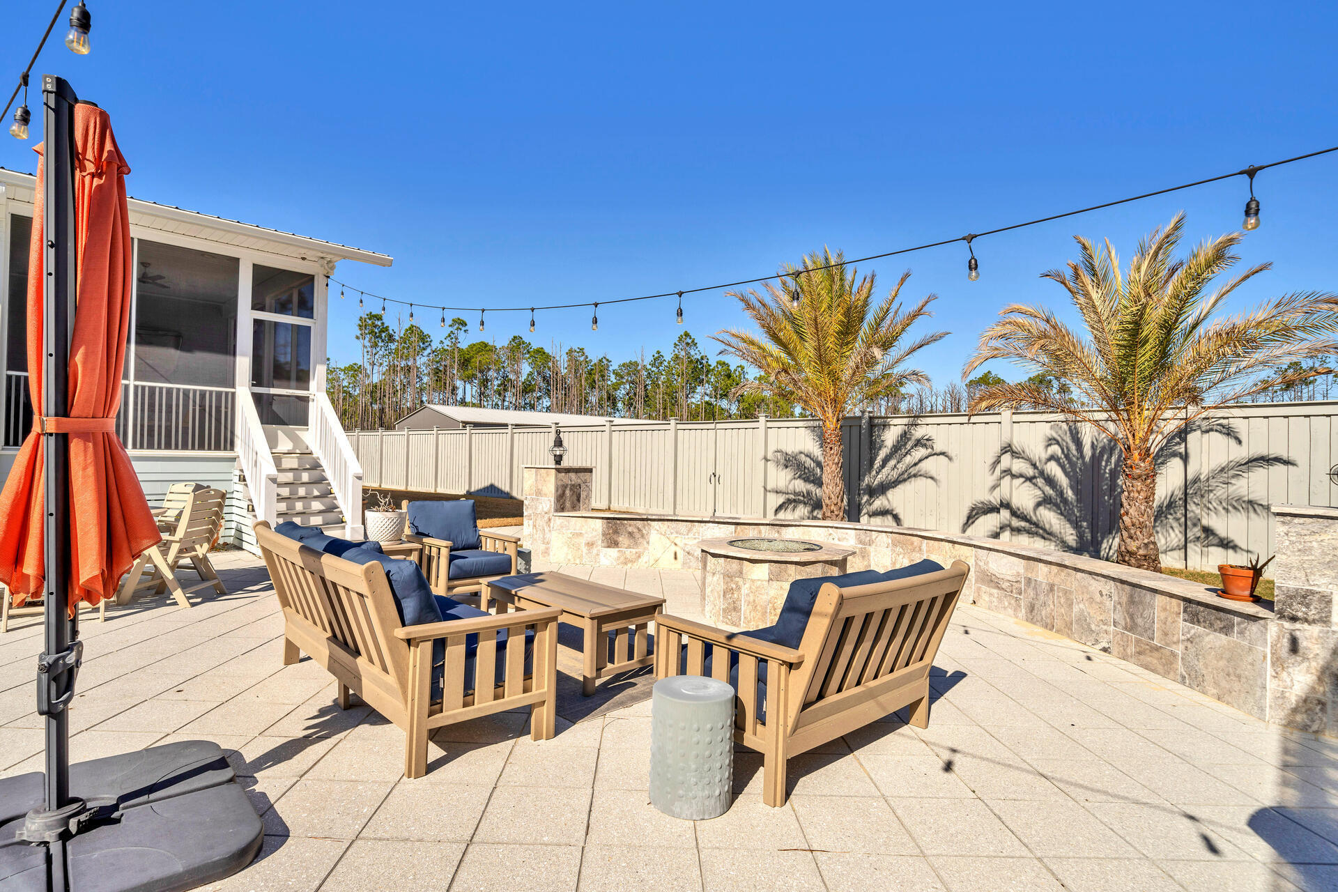 90 Delbert Lane Santa Rosa Beach, FL 32459 - Photo 43 of 47 a view of a patio with couches table and chairs and potted plants