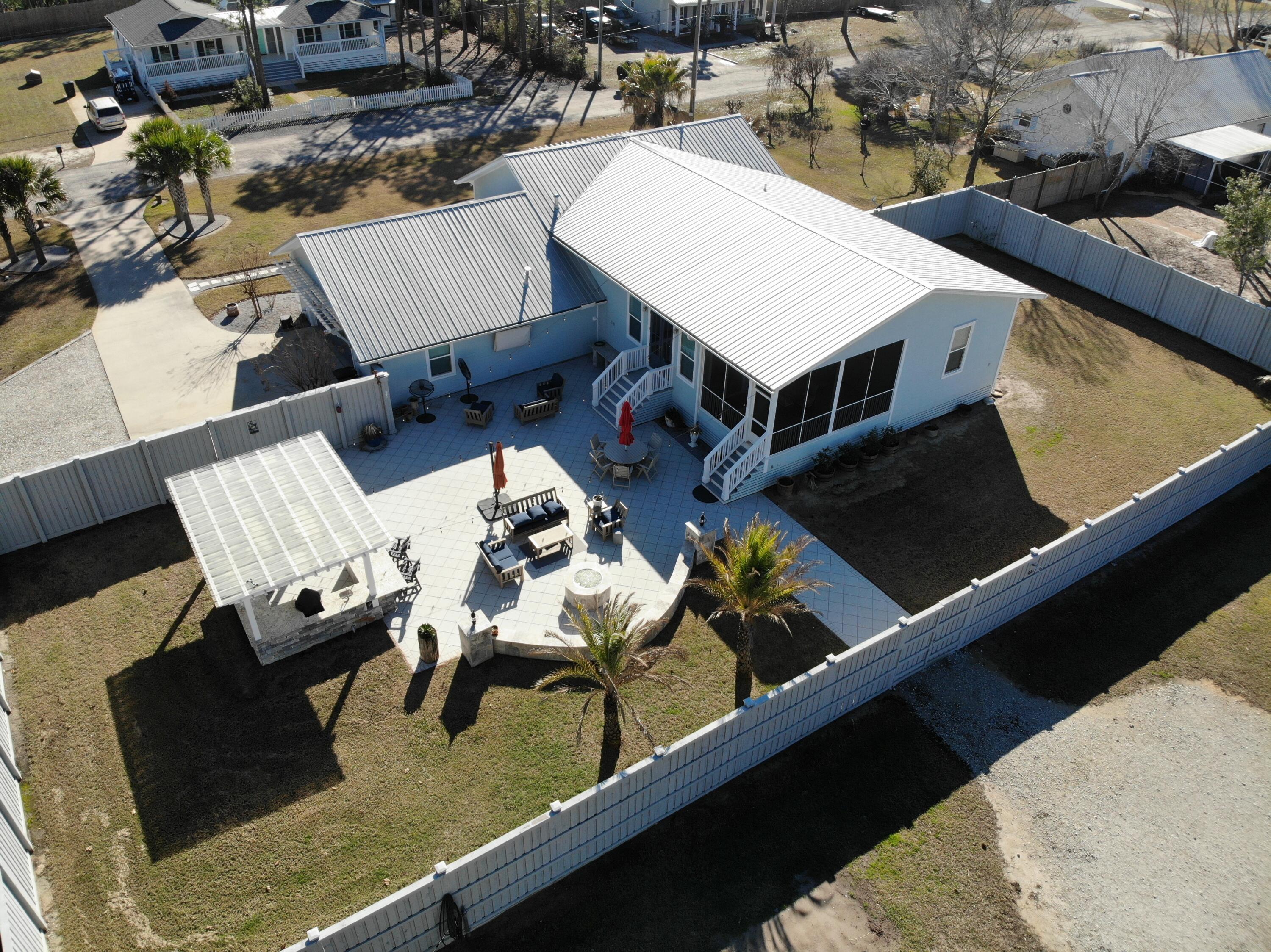 90 Delbert Lane Santa Rosa Beach, FL 32459 - Photo 47 of 47 a view of a terrace with chairs and wooden floor