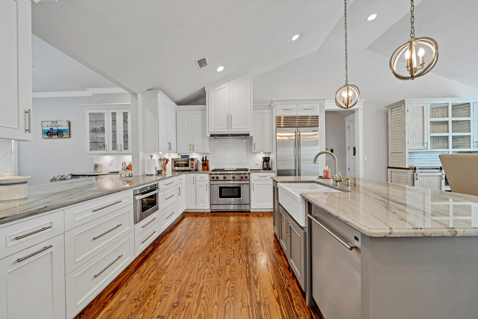 90 Delbert Lane Santa Rosa Beach, FL 32459 - Photo 6 of 47 a large kitchen with stainless steel appliances granite countertop a stove top oven a sink dishwasher and white cabinets with wooden floor