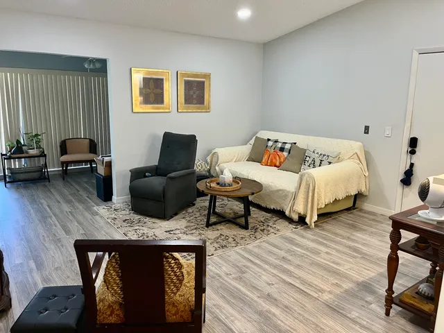 a bedroom with furniture and a wooden floor