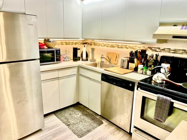 a kitchen with stainless steel appliances a refrigerator and cabinets