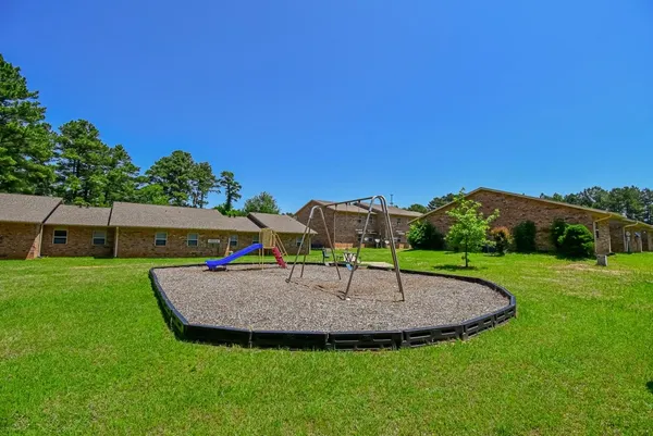a view of outdoor space with playground and green space