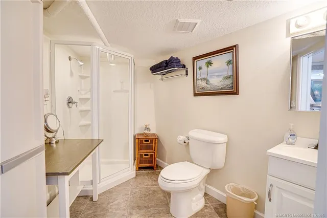 a white toilet sitting next to a bathroom sink