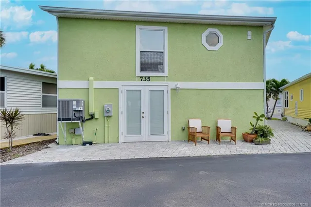 a view of a house with outdoor space and a car parked