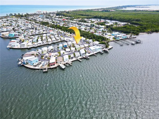 an aerial view of a house with a ocean view