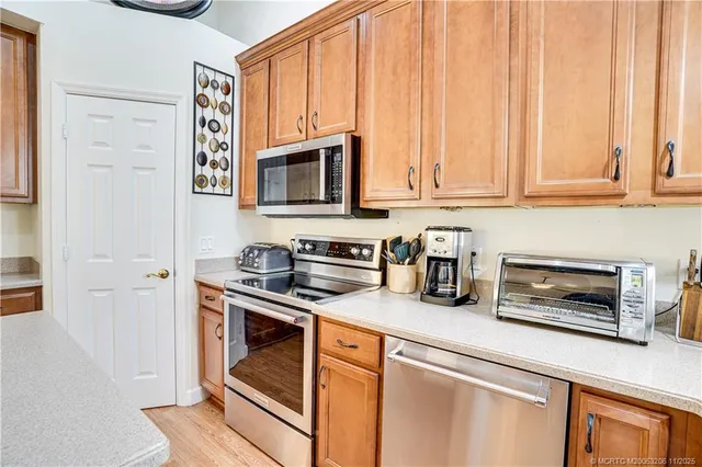 a kitchen with stainless steel appliances granite countertop a stove a microwave and cabinets