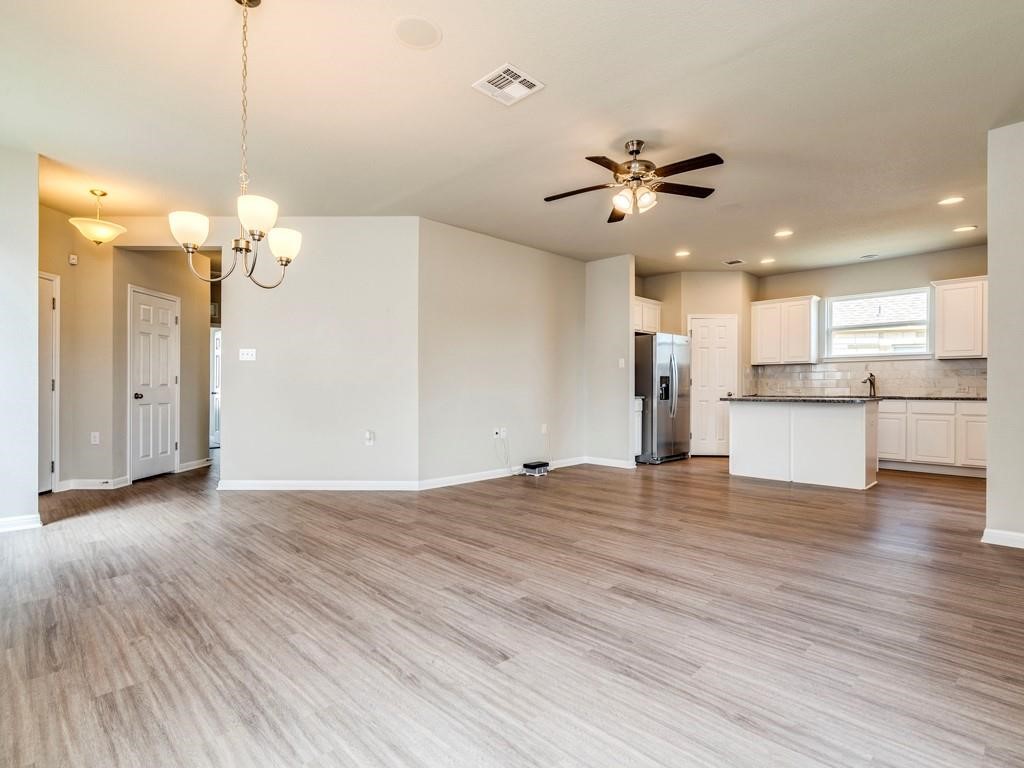 4210 Birdwatch Loop, Unit 2 Pflugerville, TX 78660 - Photo 31 of 31 An open floorplan seamlessly connects the living space to a well-appointed kitchen.