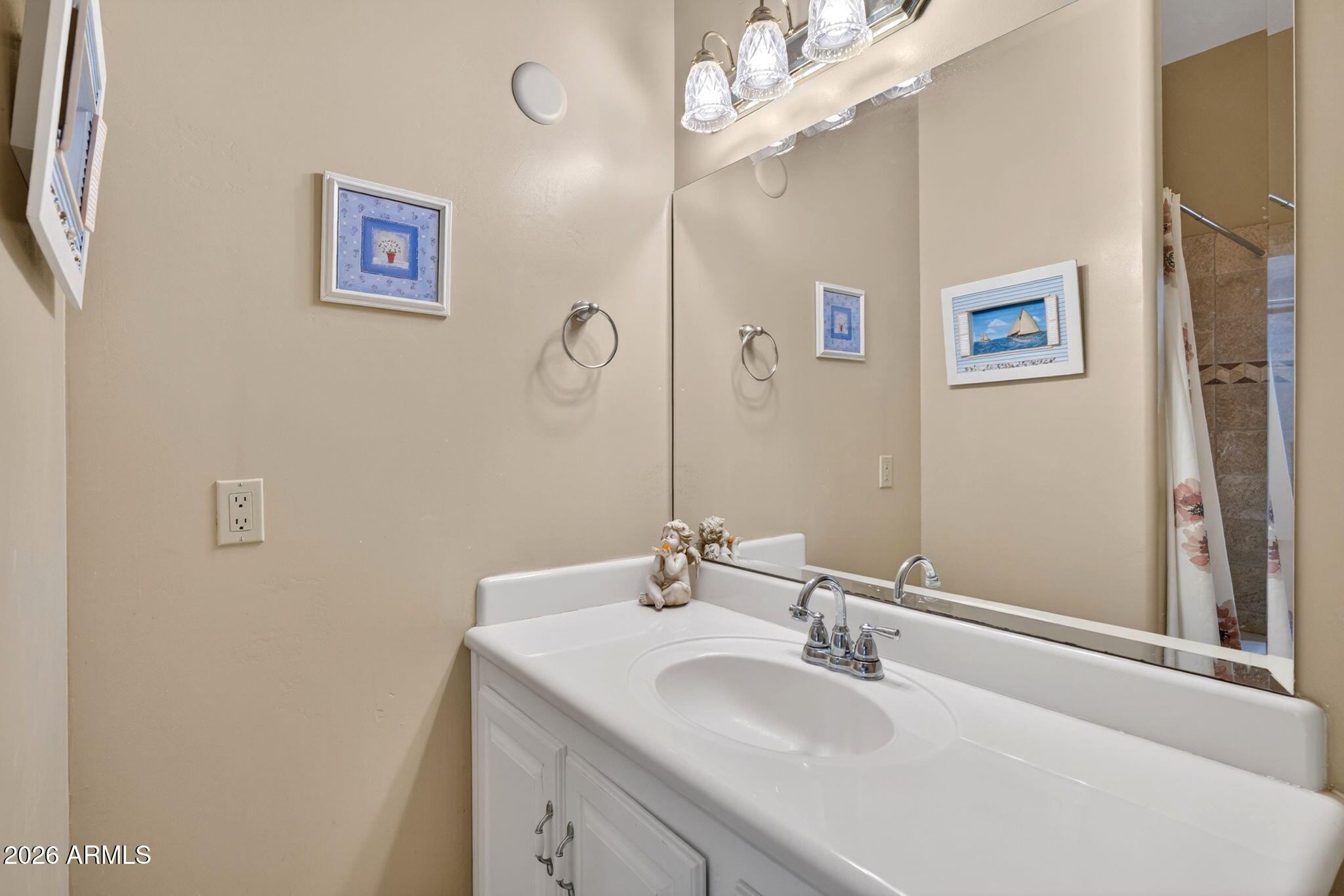 2929 West New River Road New River, AZ 85087 - Photo 29 of 53 a bathroom with a sink a mirror and a painting on the wall