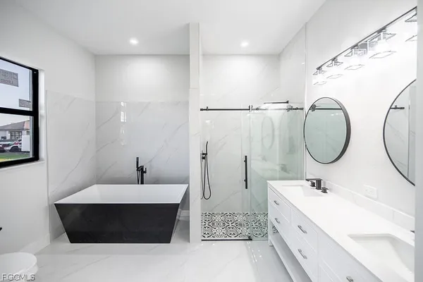 a bathroom with a double vanity sink and a mirror