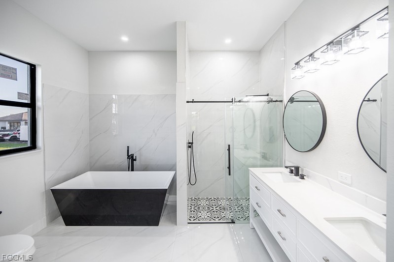 3313 36th Street Southwest Lehigh Acres, FL 33976 - Photo 15 of 27 a bathroom with a double vanity sink and a mirror