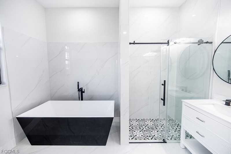 3313 36th Street Southwest Lehigh Acres, FL 33976 - Photo 17 of 27 a bathroom with a sink and a mirror