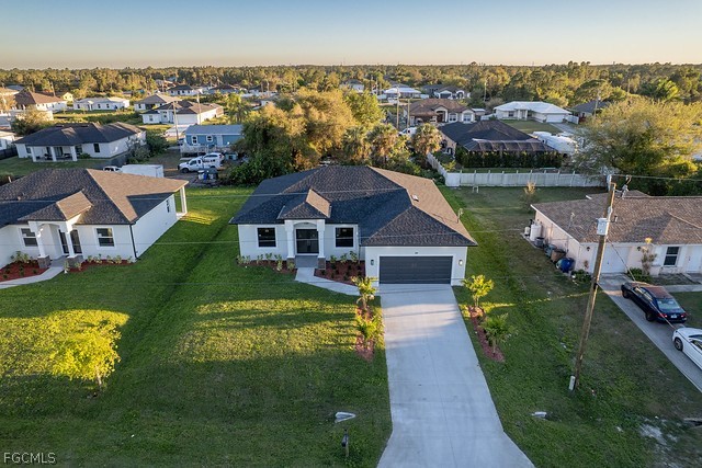 3313 36th Street Southwest Lehigh Acres, FL 33976 - Photo 2 of 27 a view of a house with a yard
