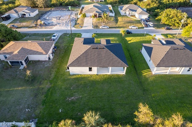 3313 36th Street Southwest Lehigh Acres, FL 33976 - Photo 25 of 27 an aerial view of a house with a garden and lake view