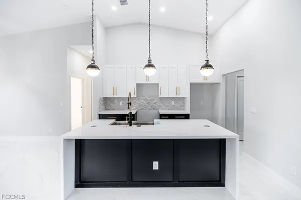 a kitchen with a sink a counter space and appliances