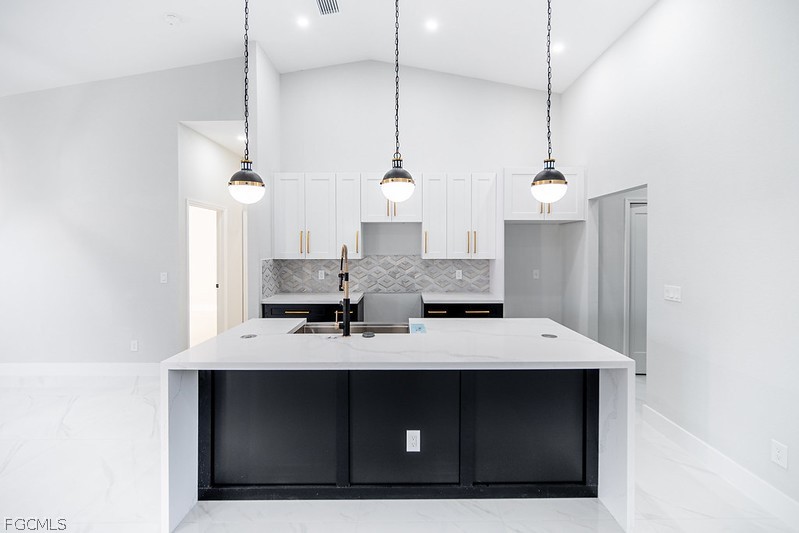 3313 36th Street Southwest Lehigh Acres, FL 33976 - Photo 9 of 27 a kitchen with a sink a counter space and appliances