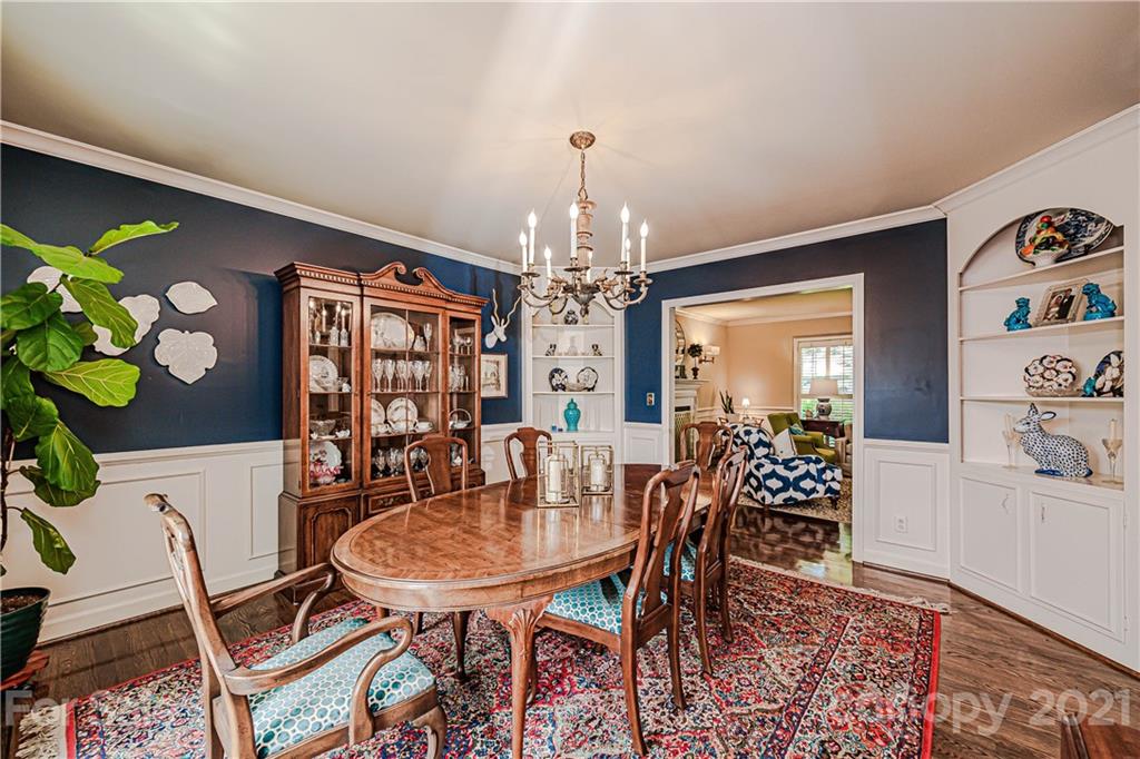 2831 Wickersham Road Charlotte, NC 28211 - Photo 11 of 47 a view of a dining room with furniture and chandelier