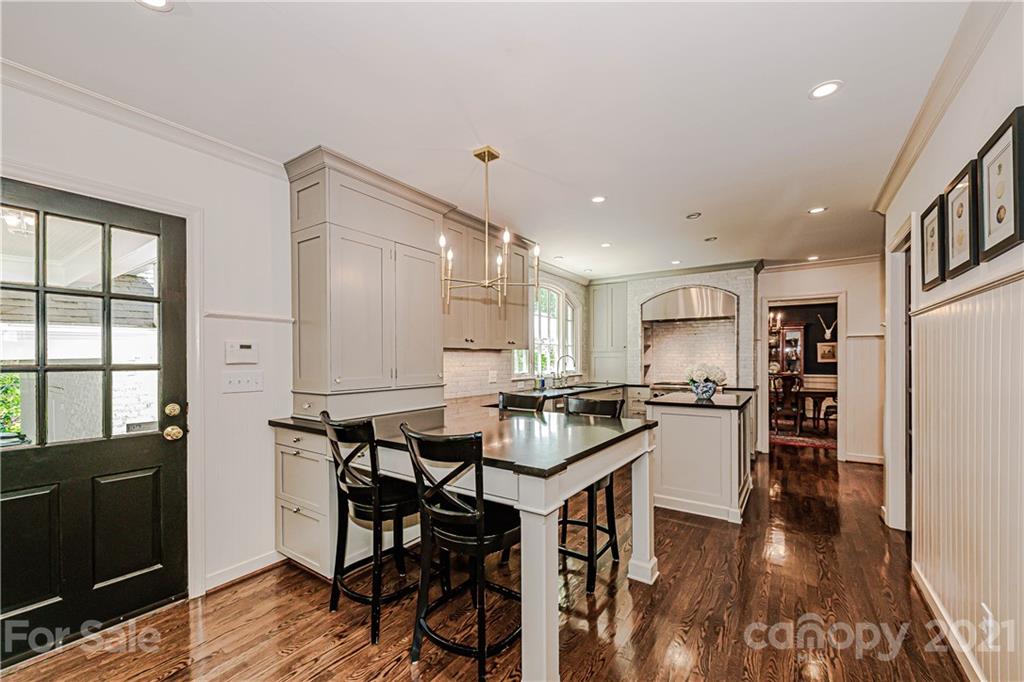 2831 Wickersham Road Charlotte, NC 28211 - Photo 15 of 47 a kitchen with stainless steel appliances kitchen island granite countertop a stove top oven a sink and a refrigerator
