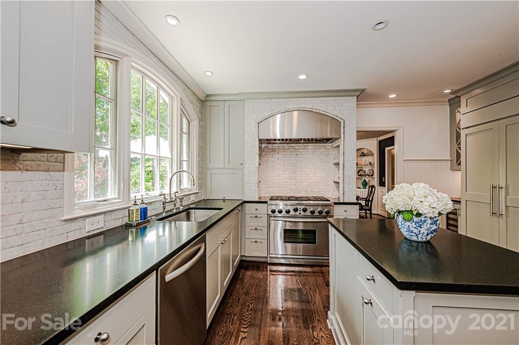 2831 Wickersham Road Charlotte, NC 28211 - Photo 17 of 47 a kitchen with stainless steel appliances granite countertop a stove a sink and a microwave