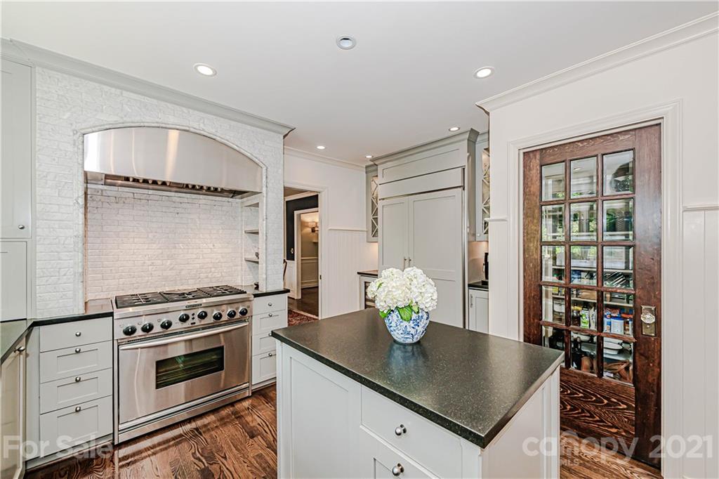 2831 Wickersham Road Charlotte, NC 28211 - Photo 18 of 47 a kitchen with granite countertop stainless steel appliances a stove a table and a dining table