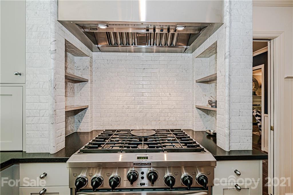 2831 Wickersham Road Charlotte, NC 28211 - Photo 19 of 47 a stove top oven sitting inside of a kitchen