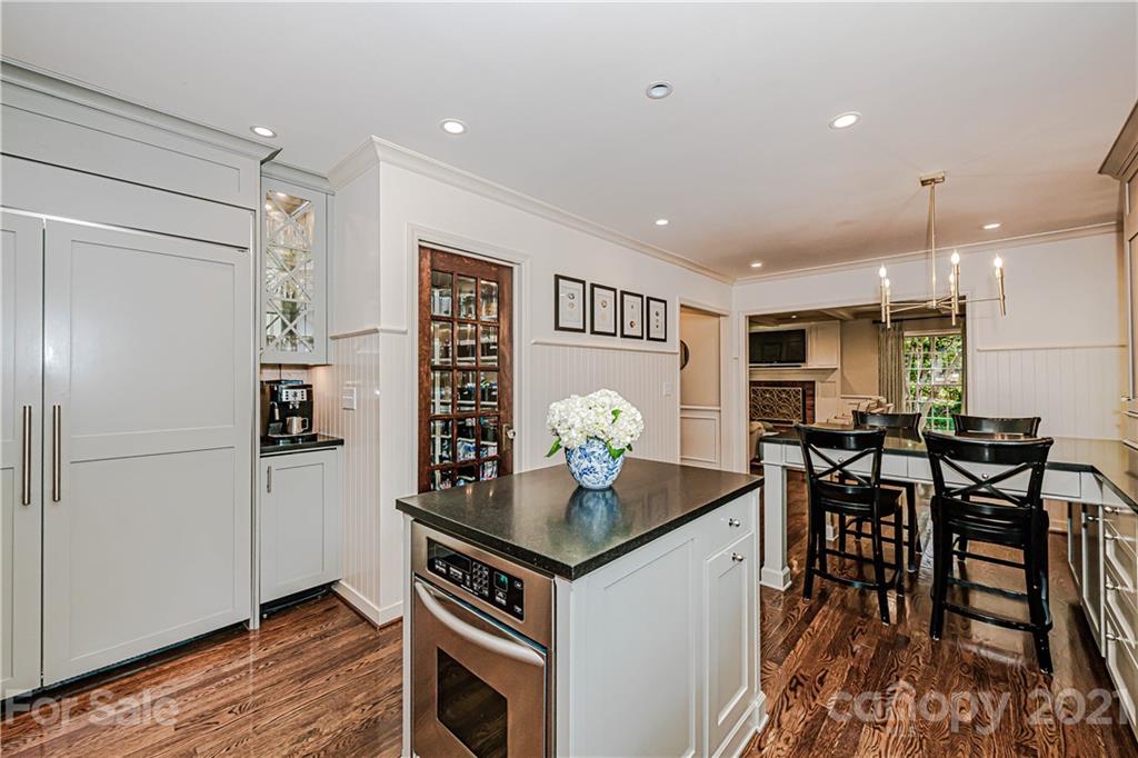 2831 Wickersham Road Charlotte, NC 28211 - Photo 21 of 47 a kitchen that has a table chairs and wooden floor